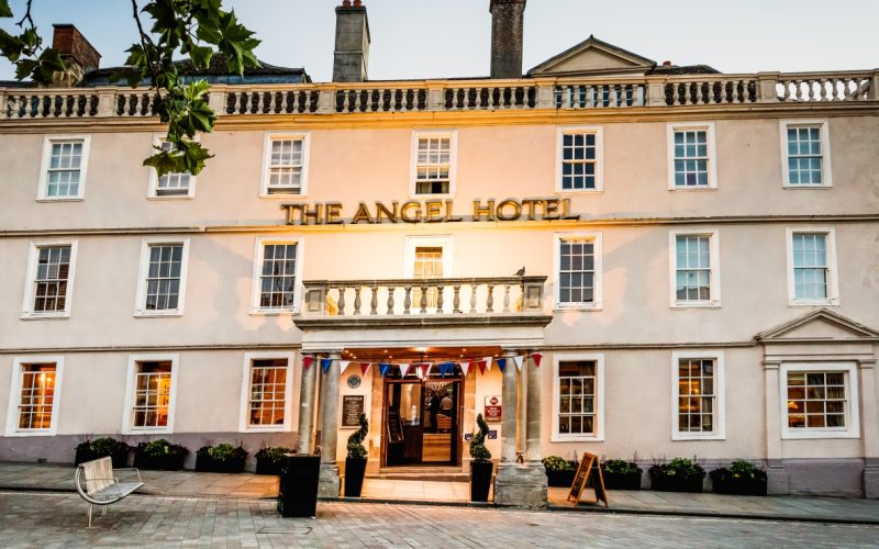 The Angel Hotel historic facade and main entrance viewed from a paved courtyard