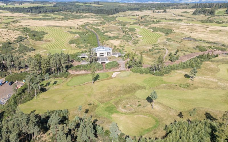 Aerial view of gWest golf course and clubhouse near Gleneagles, surrounded by rolling farmland.