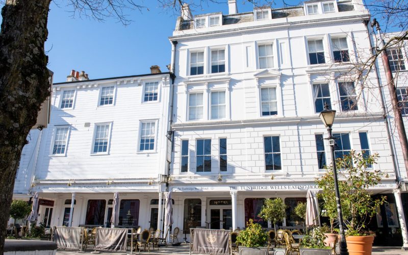The Grade II listed Tunbridge Wells Hotel on The Pantiles, with outdoor café seating and potted plants.