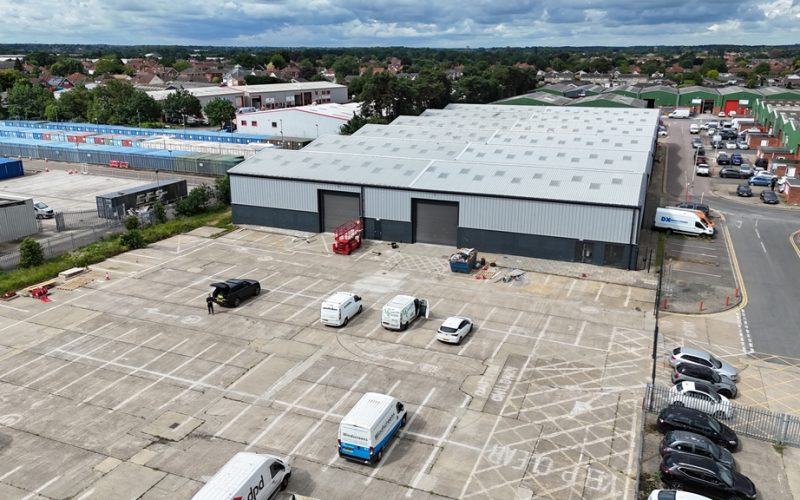 Aerial view of Union Park Industrial Estate, showing the refurbished warehouse and delivery vehicles in the parking area.