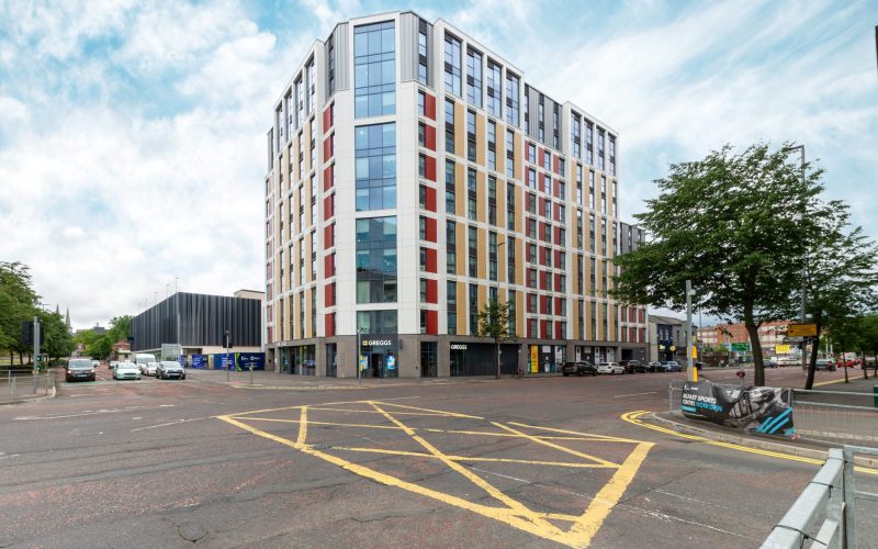 The Edge student accommodation building in Belfast, viewed from across a marked car park.