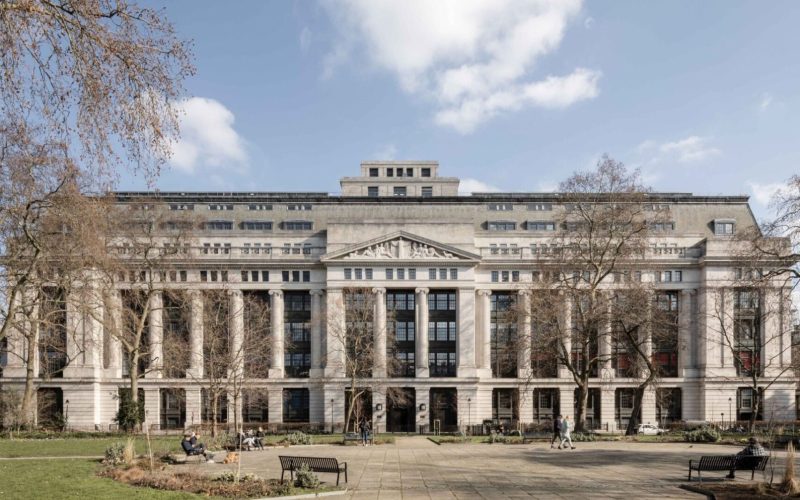 Victoria House in Bloomsbury, London, a grand neoclassical building viewed from its tree-lined plaza.
