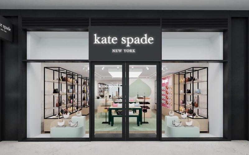 Kate Spade New York storefront at London Designer Outlet, with clothing and accessories displayed in the windows.