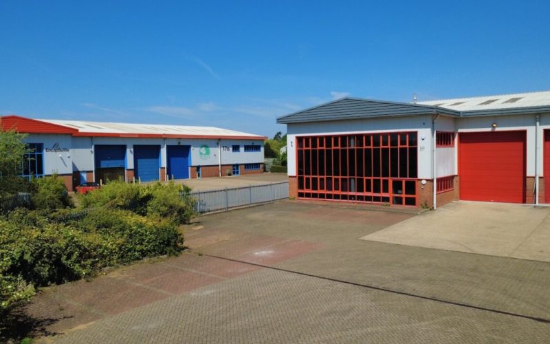 Three warehouse units at Chartmoor Road in Leighton Buzzard, with loading bays and a paved yard.