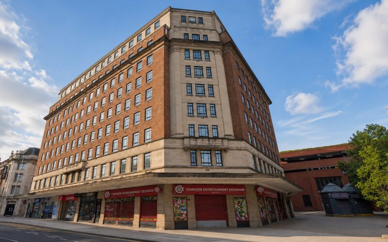 Exterior of a brick built corner office building with retail space on the ground floor