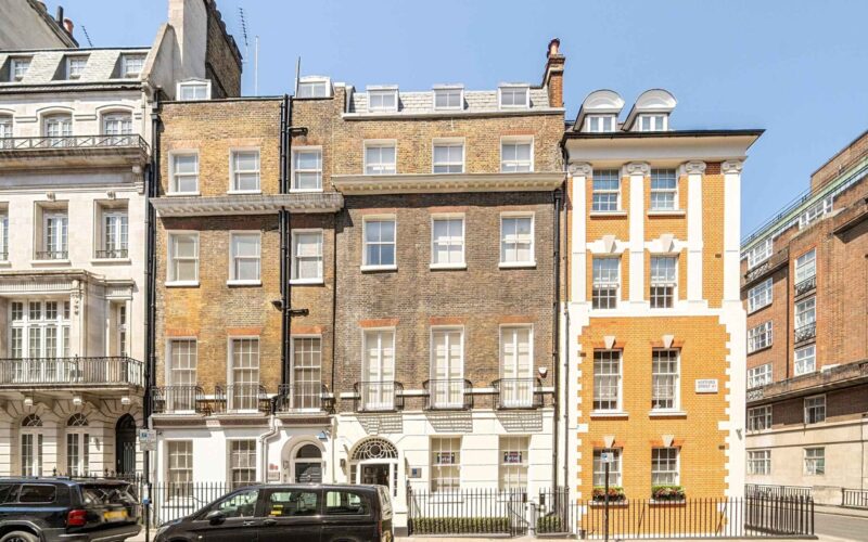 A series of different sized old office and residential buildings