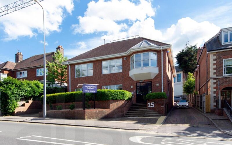 Exterior of an office building with a main road running in front