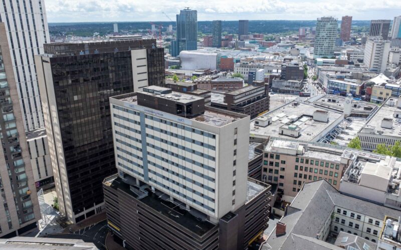 Aerial view of a student accommodation block on top of a car park in Birmingham city centre surrounded by a mix of different building types