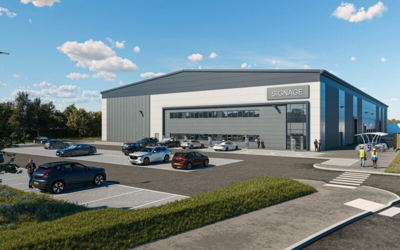 CGI of a modern industrial building with car parking in front