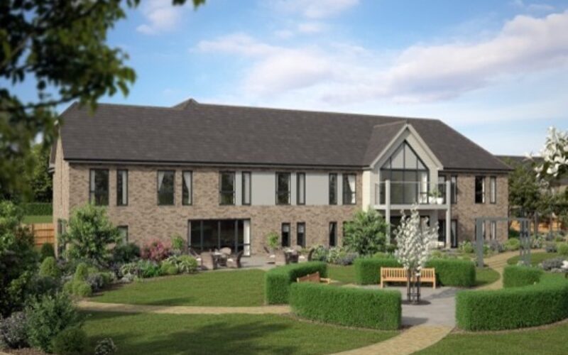 Modern low rise care home featuring landscaped lawns and gardens to the front of the property