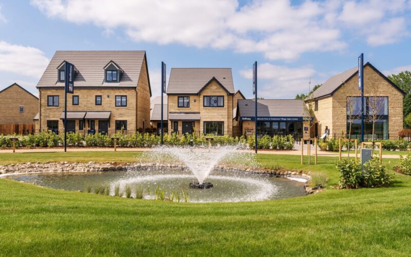 A series of new homes with a large fountain in front
