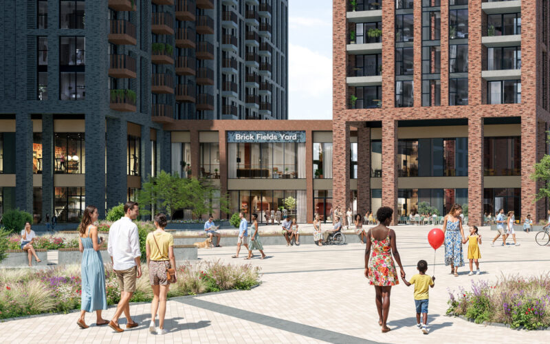 A series of different sized and coloured buildings with public realm at the front and people milling around outside