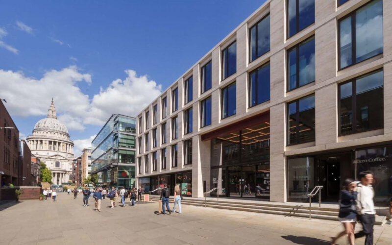 A low-rise office building with St Paul's cathedral looming large in the background