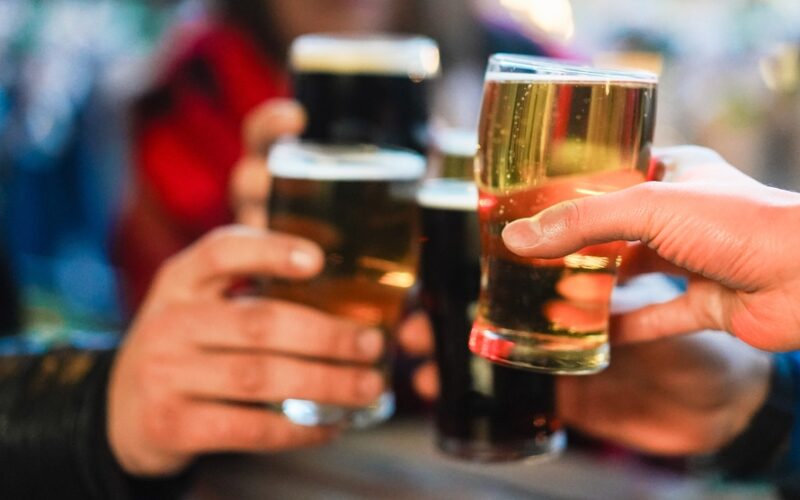 Young,Group,Of,People,Having,Fun,Cheering,With,Beer,Outdoor