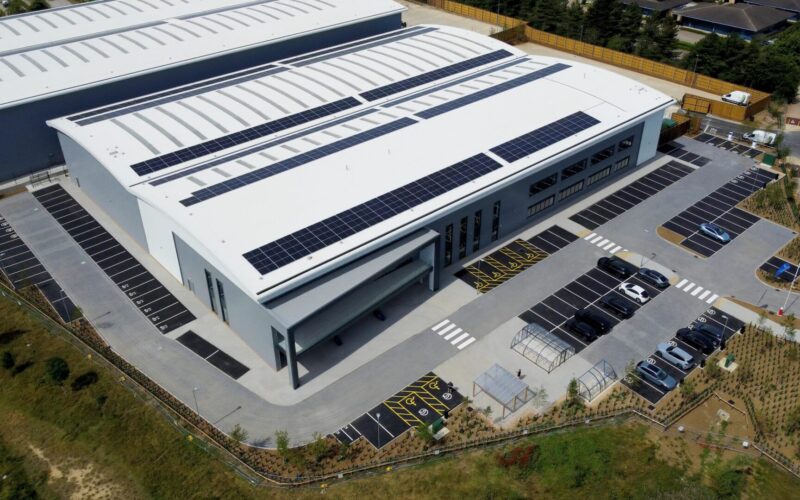 Aerial view of a modern logistics building surrounded by greenery