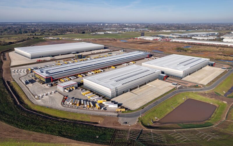Aerial view of a series of new large industrial buildings surrounded by fields