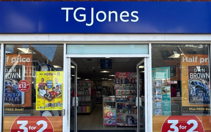 Exterior of a TG Jones store with a blue company sign above the door
