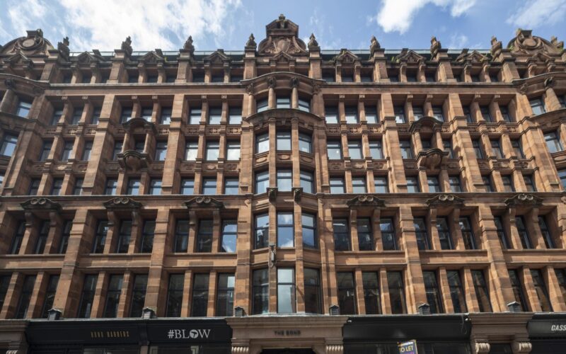 The ornate facade of a traditional building featuring lots of windows
