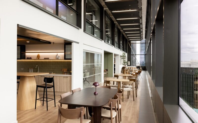 Interior of a modern office building featuring a row of tables