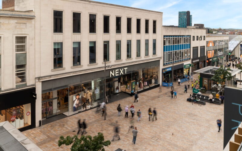 A pedestrianised high street featuring a large Next store