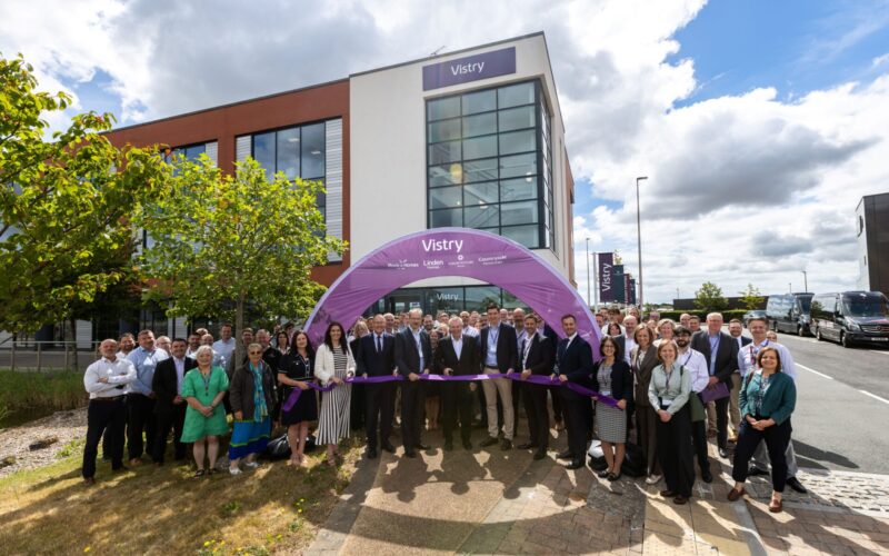Picture of lots of people stood in front of a Vistry branded archway and an office building