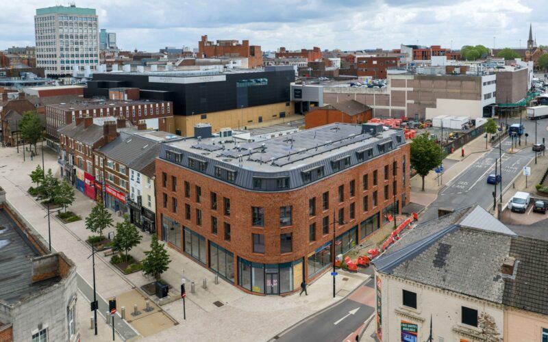 Multi-storey building with a red brick exterior in the middle of Wolverhampton surrounded by other buildings