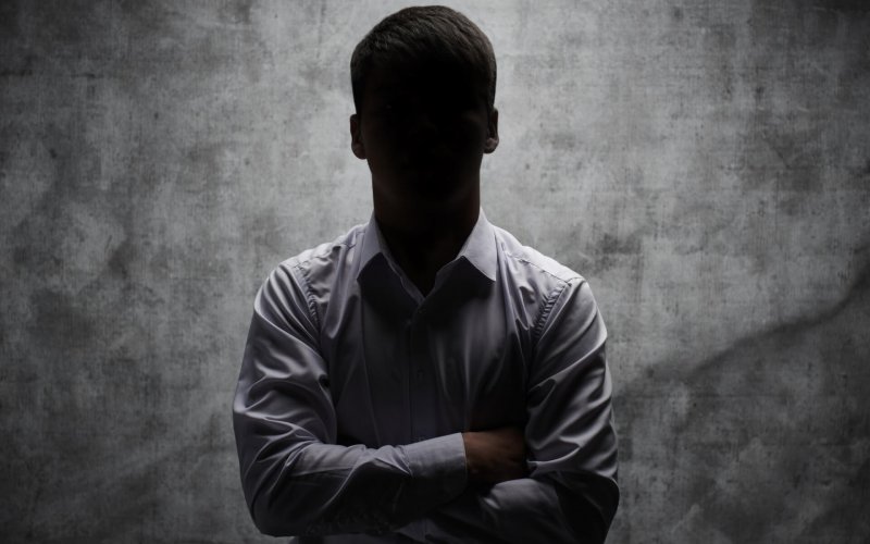Anonymous,Man,In,A,Business,Shirt,With,Arms,Crossed,Against