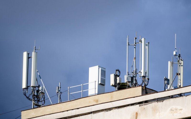 Telecommunications,Antennas,On,A,Rooftop,Of,An,Old,Building,With
