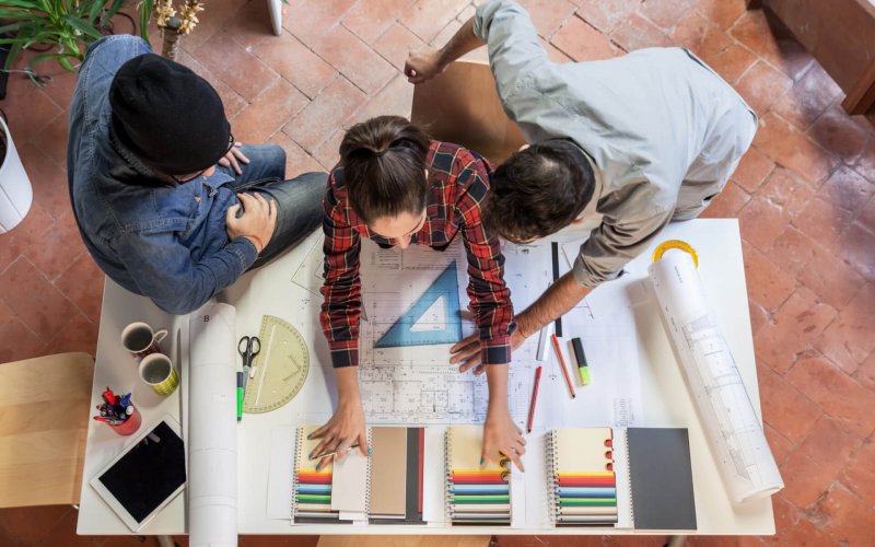 Working,Group.,Three,Young,Architects,Working,On,A,Project,At