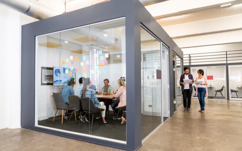 Group of people in a business meeting at a creative office sharing ideas - teamwork concepts. **IMAGE ON SCREEN WAS DESIGNED FROM SCRATCH BY US**